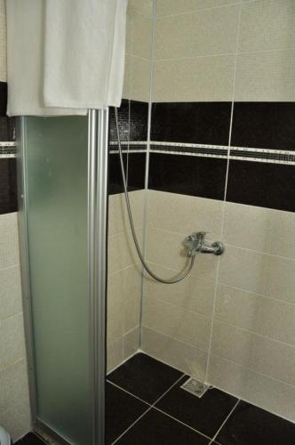 a shower with a hose in a bathroom at UnSide Apart Otel in Side