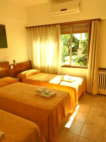 a hotel room with two beds and a window at Plaza hotel in Dolores