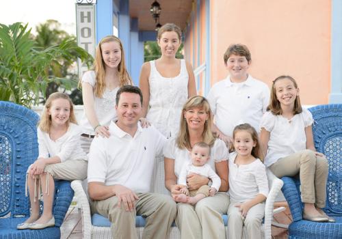 a family posing for a picture on a porch at Old Colorado Inn in Stuart