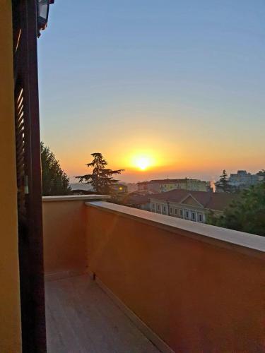 a view of a sunset from a balcony at La Sibilla in Macerata
