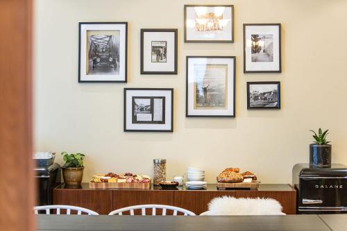 a dining room with a table and framed pictures on the wall at The Copeland in Revelstoke