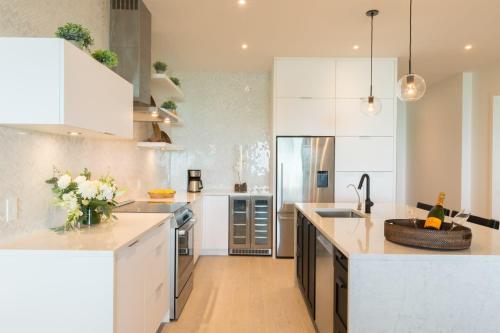 a kitchen with white cabinets and a counter top at H2O LifeStyle Resort in Long Bay Hills