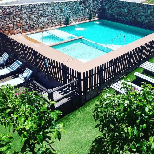 an overhead view of a swimming pool with a wooden deck at El Mirador De Ruidera in Ruidera