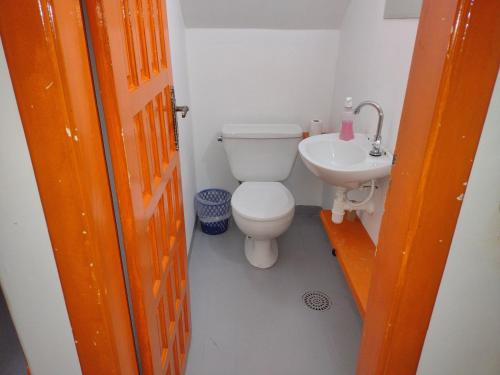 a bathroom with a toilet and a sink at COACHHOSTEL7 in Sao Paulo