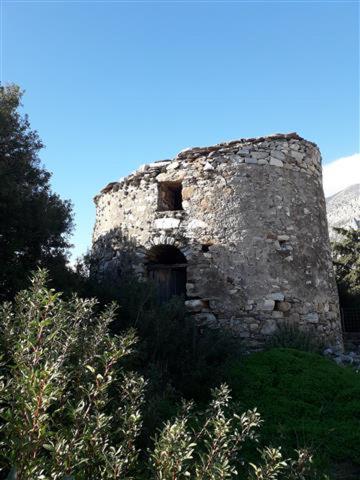 an old building sitting on top of a hill at Mythical Ikaria, Therma tiny two floors apartment in Agios Kirykos