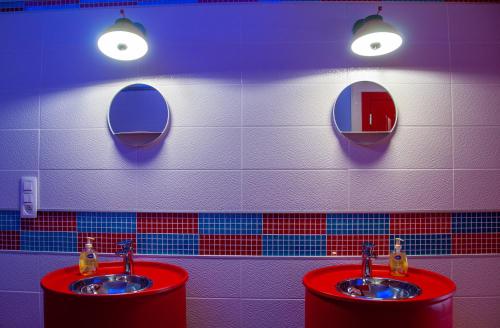 a bathroom with two sinks and two mirrors at Vip room 209 in Trooz