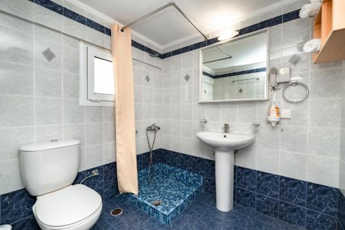 a bathroom with a toilet and a sink at Villa by Hotel Thira in Fira