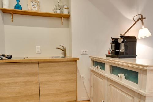 a kitchen with a counter with a coffee maker on it at La Cour Filaterie - Suite of 30 sq m in the Annecy breakfast included in Annecy