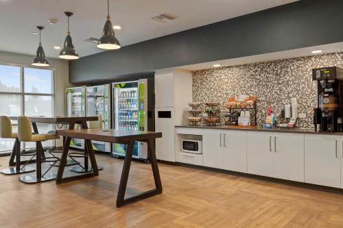 a kitchen with a table and chairs in a room at Extended Stay America Premier Suites - Orlando - Sanford in Sanford