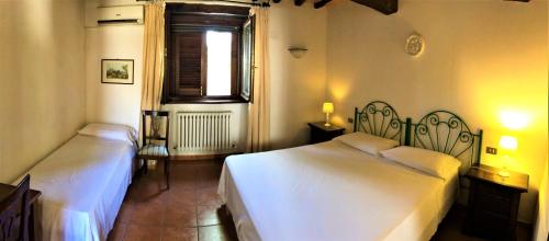 Postel nebo postele na pokoji v ubytování Agriturismo Camiano Piccolo