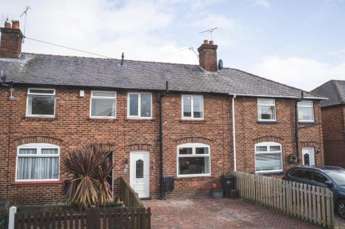 a brick house with a car parked in front of it at Stunning 3-Bed house in Chester by 53 Degrees Property, ideal for Contractors & Families, FREE Parking - Sleeps 7 in Chester
