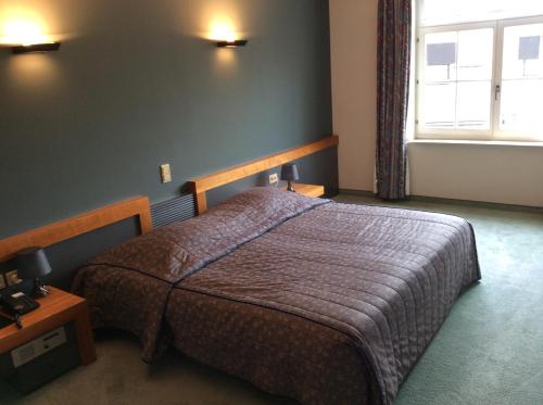 Llit o llits en una habitació de Hotel ABBEY