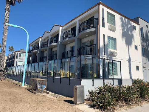 a white building with balconies on the side of it at Ocean Park Inn in San Diego