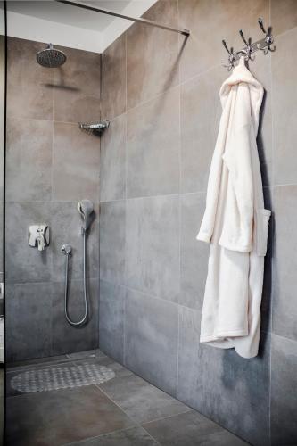 a shower with a white towel hanging on a wall at Deluxe Apartments A&A in Rovinj