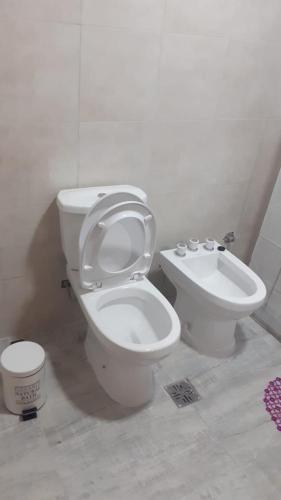 a bathroom with a toilet and a bidet at H2o apart in Federación
