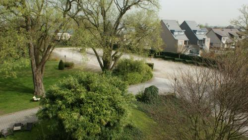 an aerial view of a park with trees and houses at Hotel ABBEY in Grimbergen