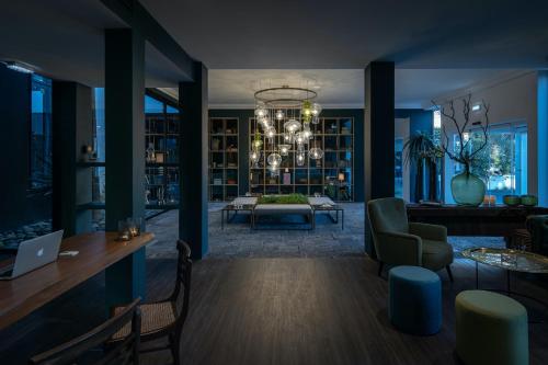 a living room with a chandelier and a table at Senhora da Rosa, Tradition & Nature Hotel in Ponta Delgada