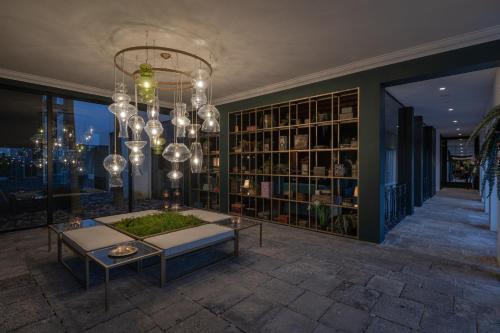 a living room with a chandelier and a table at Senhora da Rosa, Tradition & Nature Hotel in Ponta Delgada