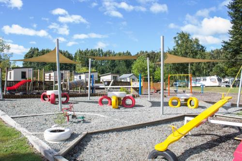 a playground with many different types of playground equipment at Te Anau Lakeview Holiday Park & Motels in Te Anau