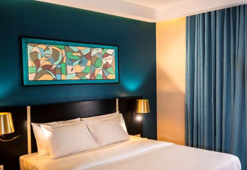 a bedroom with a bed and a painting on the wall at Best Western Plus Soaho Douala Airport in Douala