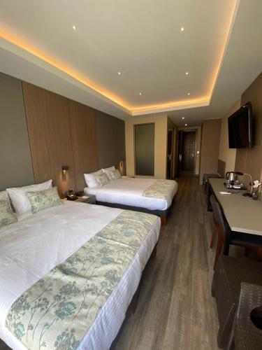 Un ou plusieurs lits dans un hébergement de l'établissement Hotel Catena