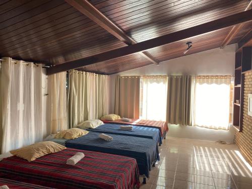 a bedroom with two beds in a room at Vila Japaraiso-Casa Amarela Próxima ao mar in Japaratinga