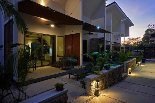 a house with a patio with plants and lights at NATURA Loft Garden in Santa Teresa Beach