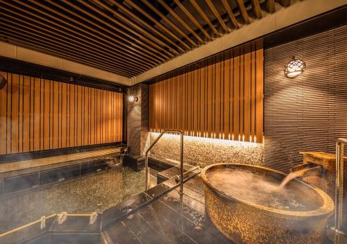 a bathroom with a bath tub in a room at APA Hotel & Resort Hakata Ekihigashi in Fukuoka