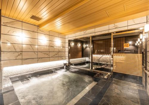 a room with a pool of water in a building at APA Hotel & Resort Hakata Ekihigashi in Fukuoka