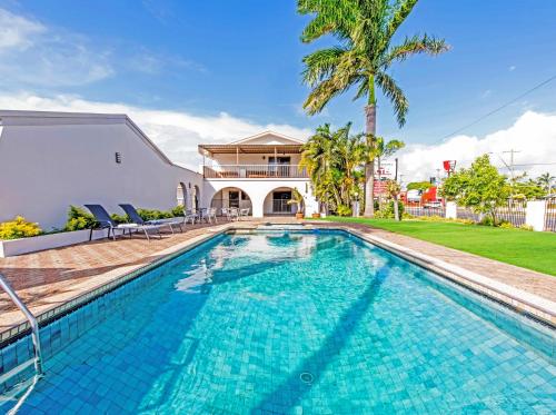 a swimming pool in the backyard of a house at Casa Nostra Motel Mackay in Mackay