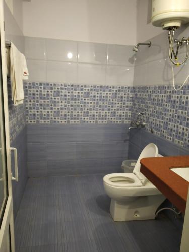 a bathroom with a toilet and a sink at ROYAL BREEZE HOTEL & RESTAURANT Received Most Rated Traveller Award Property For Year 2023-2024 !! in Mussoorie