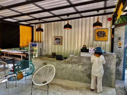 a woman standing at a counter in a restaurant at BeachBox@Koh Сhang in Ko Chang
