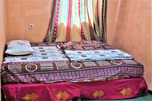 a bed in a room with two quilts on it at Villa Orange Lembang Pengkolan in Lembang