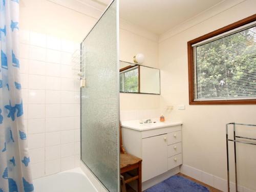 a bathroom with a shower and a sink at Spacious Adventure Getaway by the Bush & Ocean in Macmasters Beach