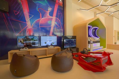 a living room with two bean bags and a tv at Club Mahindra Assonora in Assonora