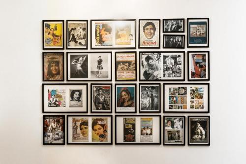 a bunch of pictures on a wall at StayVista at Saanu Ki Villa with free Breakfast in Candolim