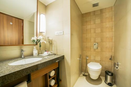 a bathroom with a sink and a toilet at Club Mahindra Assonora in Assonora