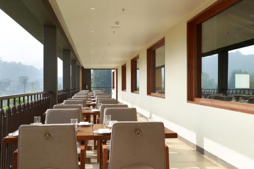 a row of tables and chairs in a restaurant at Club Mahindra Assonora in Assonora