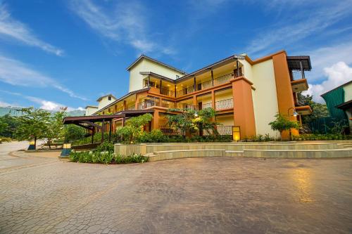 a large building on a street in front at Club Mahindra Assonora in Assonora