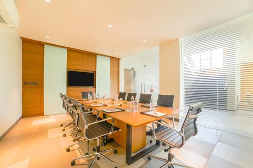 a large conference room with a long table and chairs at Club Mahindra Assonora in Assonora