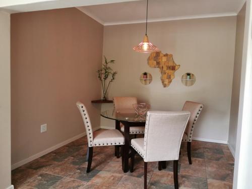 a dining room with a table and chairs at Ducks Nest in Malelane