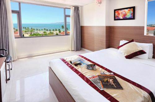 a bedroom with a bed and a large window at Arise Seaside Hotel in Nha Trang