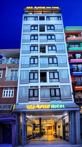 a tall building with a hotel sign in front of it at Arise Seaside Hotel in Nha Trang