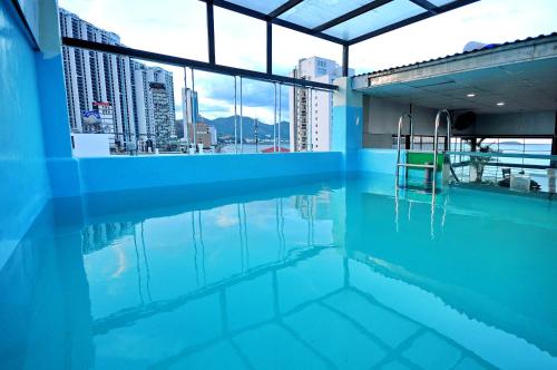 a swimming pool with a view of a city at Arise Seaside Hotel in Nha Trang