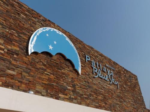 a brick building with a sign on top of it at Pattaya Blue Sky in Pattaya Central