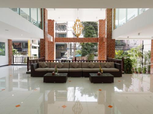 a living room with a couch in a building at Pattaya Blue Sky in Pattaya Central