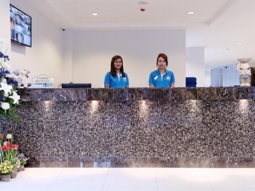 two women standing behind a counter in a lobby at Pattaya Blue Sky in Pattaya Central