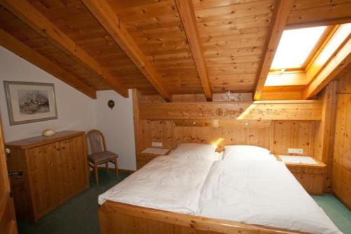 a bedroom with a large bed in a wooden room at Kleinreiterhof in Bad Reichenhall