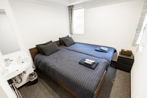 Postel nebo postele na pokoji v ubytování Port House Shibuya