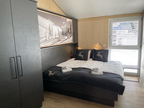 a bedroom with a bed with a picture on the wall at Villa Kreischberg in Sankt Lorenzen ob Murau